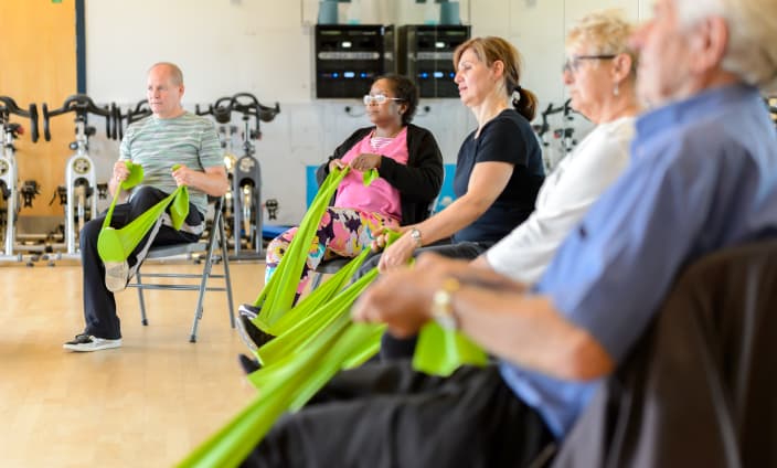 Seated exercise session with resistance bands for Forever Active